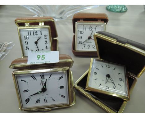 Four vintage travel clocks