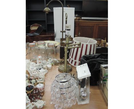 Two brassed table lamps, a light shade with glass droplets and curtain ties