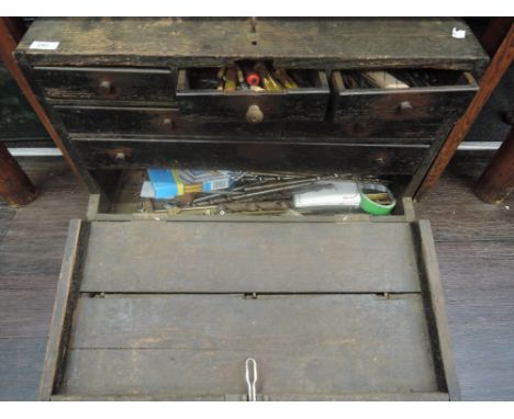 A wooden drawered tool box and contents