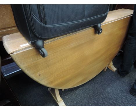An Ercol style large Sutherland type drop leaf dining table