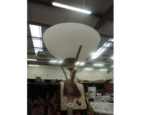 A modern brushed brass standard uplighter lamp