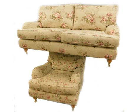 A Multi York two seater sofa, upholstered in floral fabric, decorated with roses, leaves etc., on turned legs with brass cast