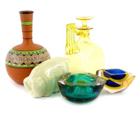 A collection of ceramic glass, to include a yellow tinted claret jug, two art glass ashtrays, a pottery bottle and a pig. (5)