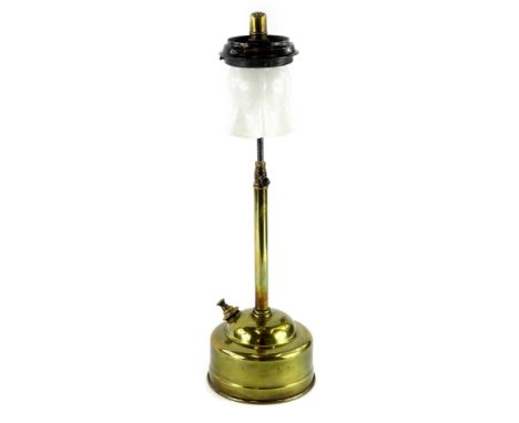 A brass Tilly lamp, with a white opaque glass shade.
