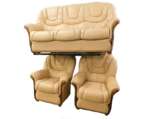 A cream leather three piece suite, comprising three seater sofa with beech show frame and two matching armchairs.