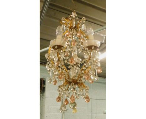A five branch gilt metal chandelier, suspended with pink and clear drops, 55cm H.
