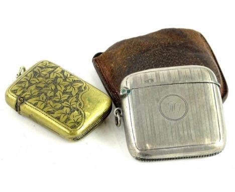 A George V silver vesta case, with engine turned striped decoration, Birmingham 1919, and an engraved brass vesta case (2).