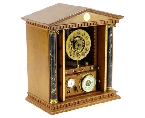 An unusual clock and weather station, housed in a cabinet previously containing the Millennium coin collection, the interior 