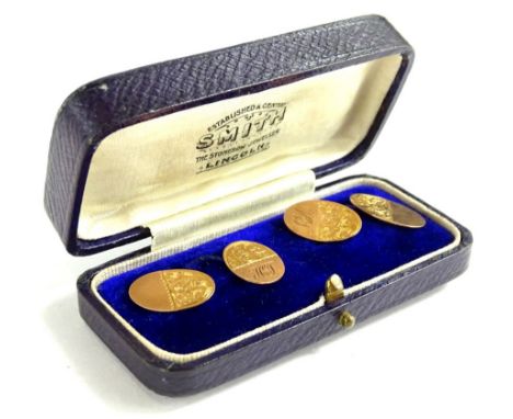 A pair of 9ct gold oval cufflinks, each with half engine turned design of floral scrolls, bearing initials HJ, in Smith Jewel