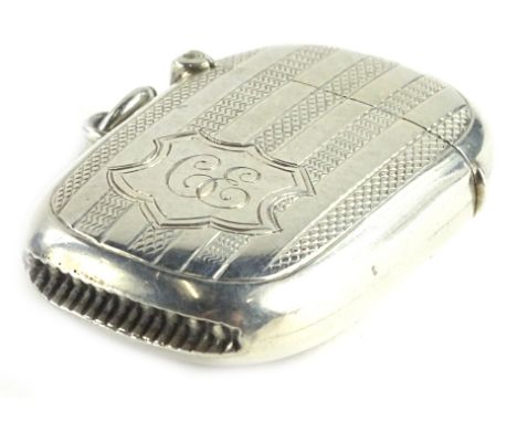 An Edwardian silver Vesta case, of rectangular form with rounded corners, engraved with engine turned bands and a shaped cart