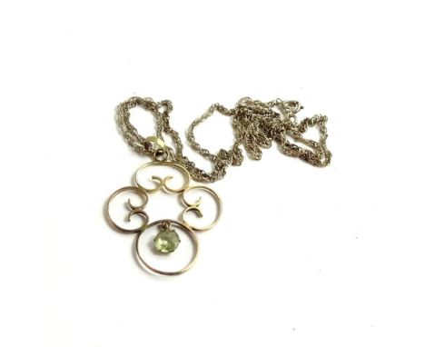 An Art Nouveau style pendant and chain, with single four section ball drop, set with pale green stone, on silver chain, stamp