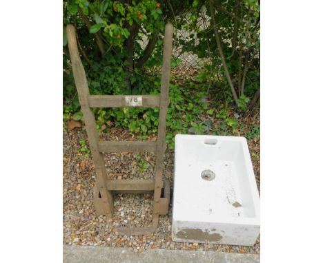 A set of iron and wooden sack barrows (AF) and a Lilco ceramic Belfast sink.