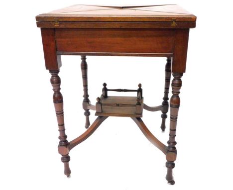 An Edwardian walnut envelope card table, the square top hinged to enclose a lined interior above a frieze drawer, on turned s