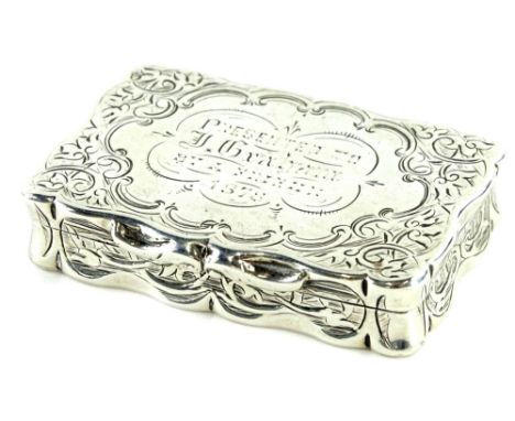 A Victorian silver rectangular snuff box, the hinged lid engraved with scrolls and with inscription, presented to J Graham et