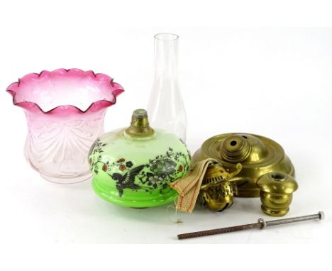 A Victorian brass oil lamp, with green opaque glass reservoir and cranberry tinted shade, (AF).