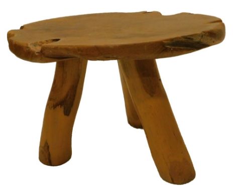 A rustic hardwood coffee table, the circular top made from a single slice from a trunk on three similar tapering legs, 72cm d