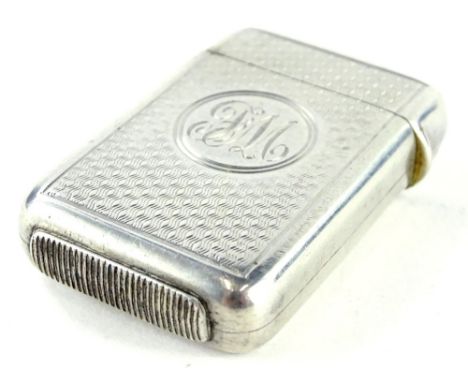A late Victorian silver Vesta case, with engine turned decoration and engraved monogram to the circular cartouche, London 188