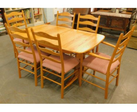 An Ercol light elm extending dining table, the rectangular top with  moulded edge on end supports, the top 88cm x 151cm, and 