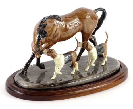 A ceramic figure group, depicting a horse and two hounds, plaque to underside Heredites, on mahogany base, 28cm W.