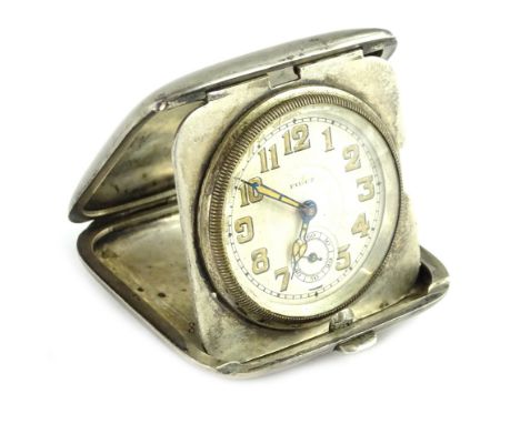A Continental white metal Art Deco travelling clock, the case engraved with niello type decoration LL, engraved to the interi