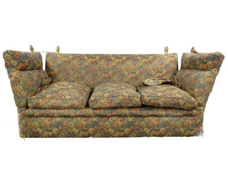 An Edwardian Knowle three seater sofa, upholstered in floral fabric with ceramic castors, 205cm wide. 