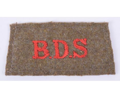 Scarce Un-Official Bomb Disposal Squad or Service Slip-on Shoulder Title, red embroidered “B.D.S” on khaki backing. Complete 