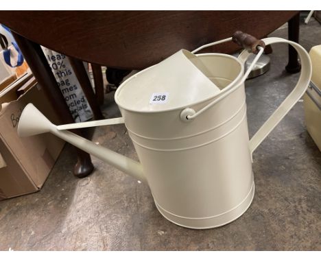 CREAM ENAMEL METAL WATERING CAN AND A WIRE WORK CANDLE HOLDER 