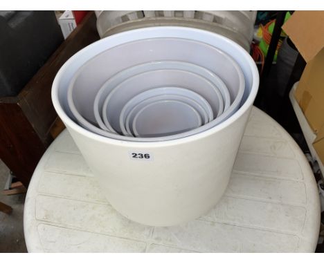 SET OF SIX GREY GRADUATED PLANTERS INSIDE A LARGER CREAM PLANTER 