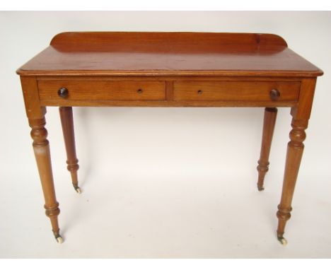 A Victorian mahogany side table, the rectangular top with back rail and moulded edge above two frieze drawers, raised on tape