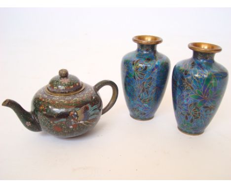 A late 19th Century Japanese cloisonne miniature teapot, of compressed circular form with loop handle, the cover with peony f