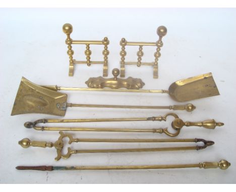 A late Victorian three piece set of brass fire tools, a apir of brass fire dogs etc. 