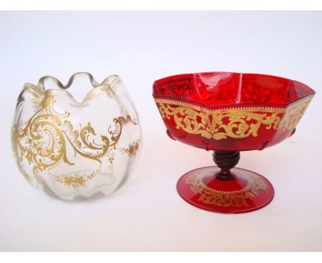 A Venetian ruby red glass comport, foliate gilt decorated and enamelled, the panelled bowl on wrythen knop stem on spreading 