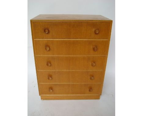 A 20th century light oak chest with five long drawers.