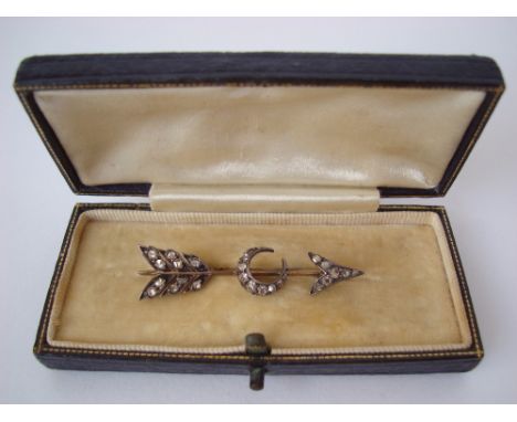 A late Victorian diamond set arrow brooch, with crescent to centre, the flight, tip and crescent pave set with old cut stones