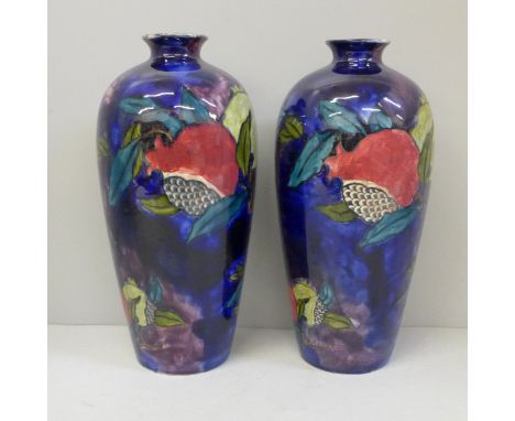 A pair of Rubens Ware vases decorated with open pomegranates, 24cm 