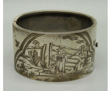 A c1900 nursery rhyme bangle with hand engraved decoration, 38mm deep, opening 48 x 58mm 