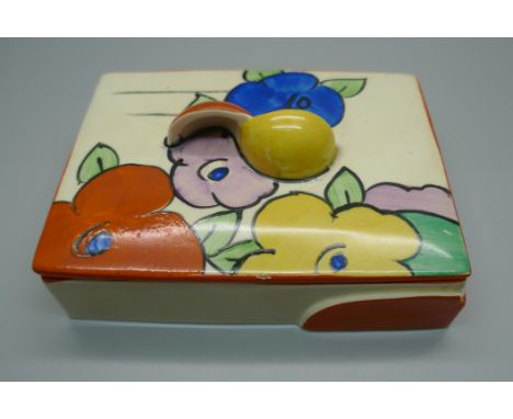A Clarice Cliff Fantasque lidded pot, 11.5cm wide, star crack to the lid 