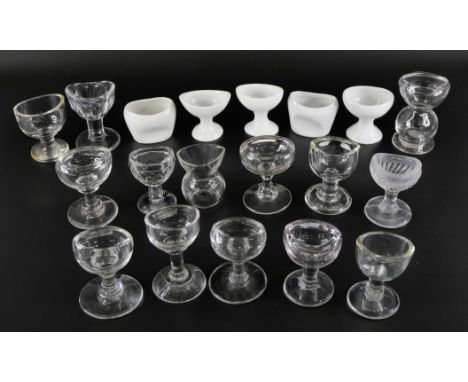 A collection of clear glass eye baths and ceramic eye baths (19) 