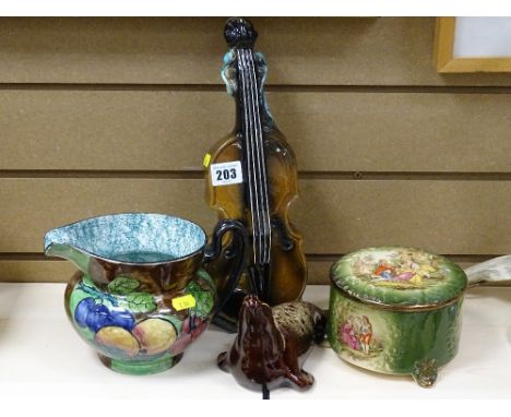 S Hancock &amp; Sons fruit decorated jug, a music box ceramic decanter in the form of a cello, a ceramic model of a seal and 