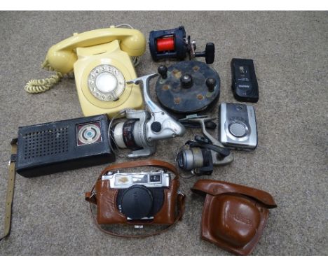 Basket of collectables including vintage dial-up telephone, fishing reels, cased camera etc