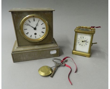 A Victorian slate mantel clock and a carriage clock. The former 19 cm high.