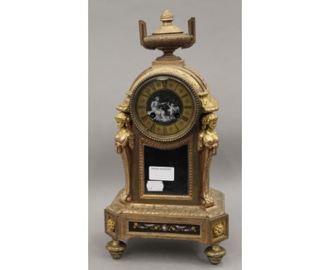 A 19th century French gilt mantle clock, set with Sevres style porcelain panels. 38 cm high.