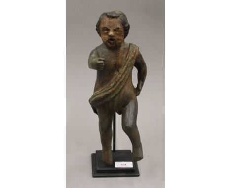 An 18th/19th century carved wooden model of an infant with sash, on metal base. 35 cm high.