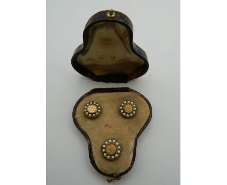 A cased set of seed pearl set studs.