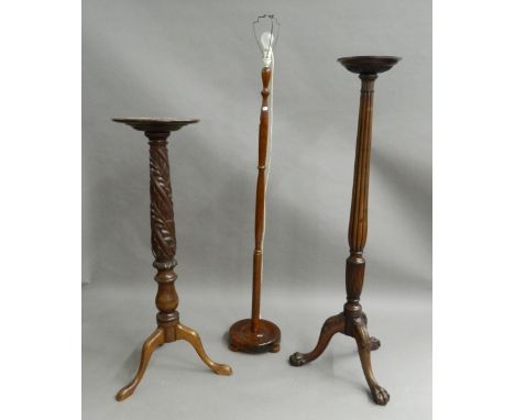 Two mahogany torcheres and a standard lamp. The lamp 171 cm high.
