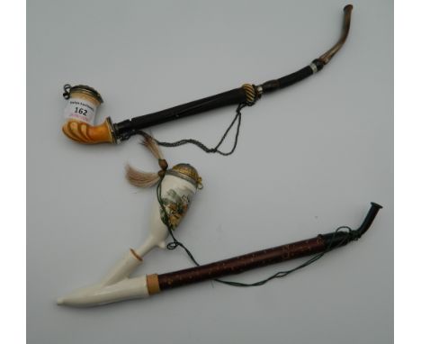 A 19th century horn and Meerschaum pipe, together with another. The former 34 cm long.