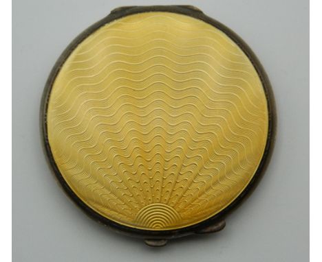 An enamel decorated silver compact