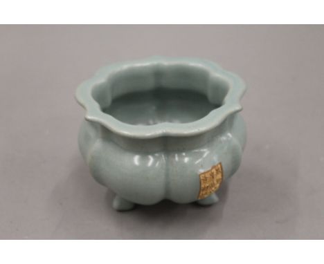 A Chinese celadon glaze censer with calligraphic panel. 12 cm wide.