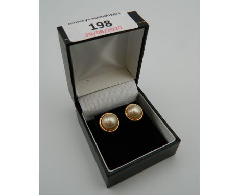 A pair of 9 ct gold and marble pearl earrings. 1.2 cm diameter (4 grammes total weight)