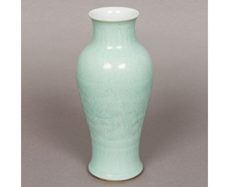 A Chinese porcelain vaseOf slender baluster form, with all over celadon glaze, the underside with blue painted seal mark.  23